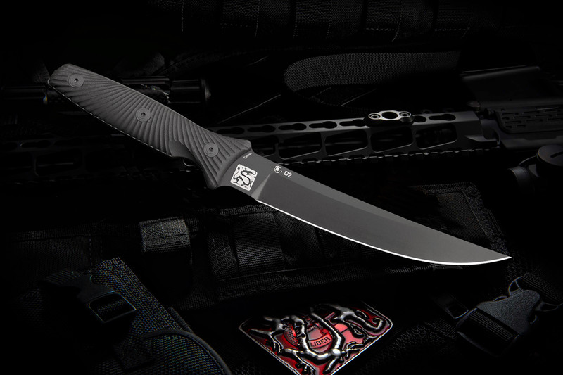 "Close-up of the Spartan-Ronin Torii knife with a black handle. The knife's blade is crafted from premium D2 steel, showcasing its rugged and tactical design."