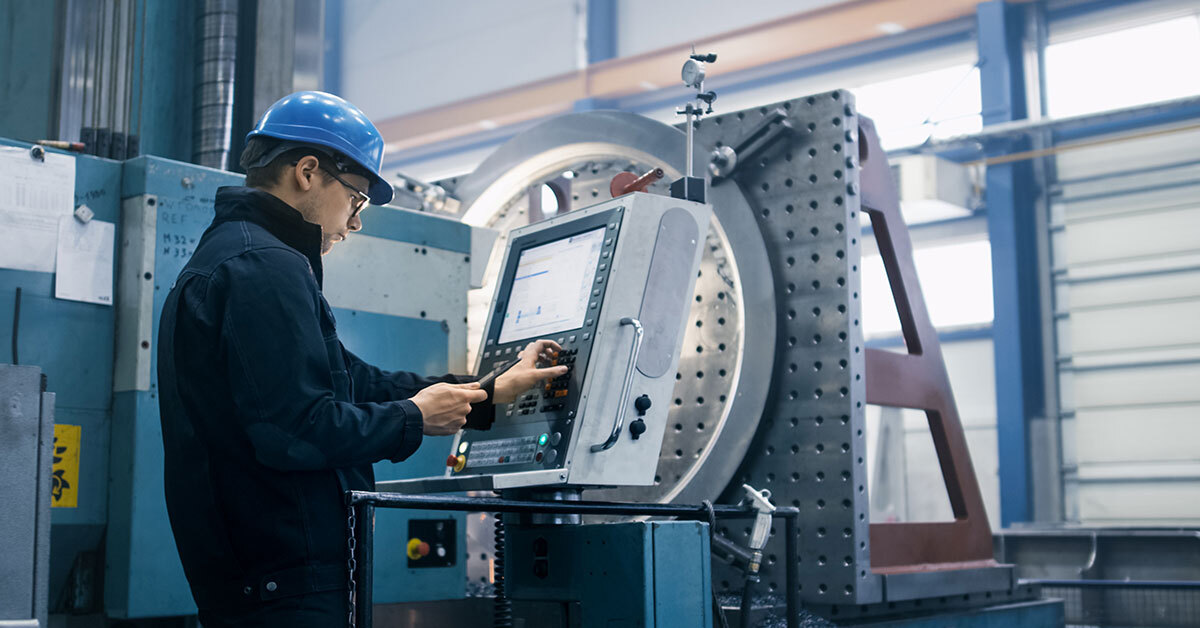 A 
  Sonic Tools Machinist adjusting and studying the machine settings to ensure measured accuracy.