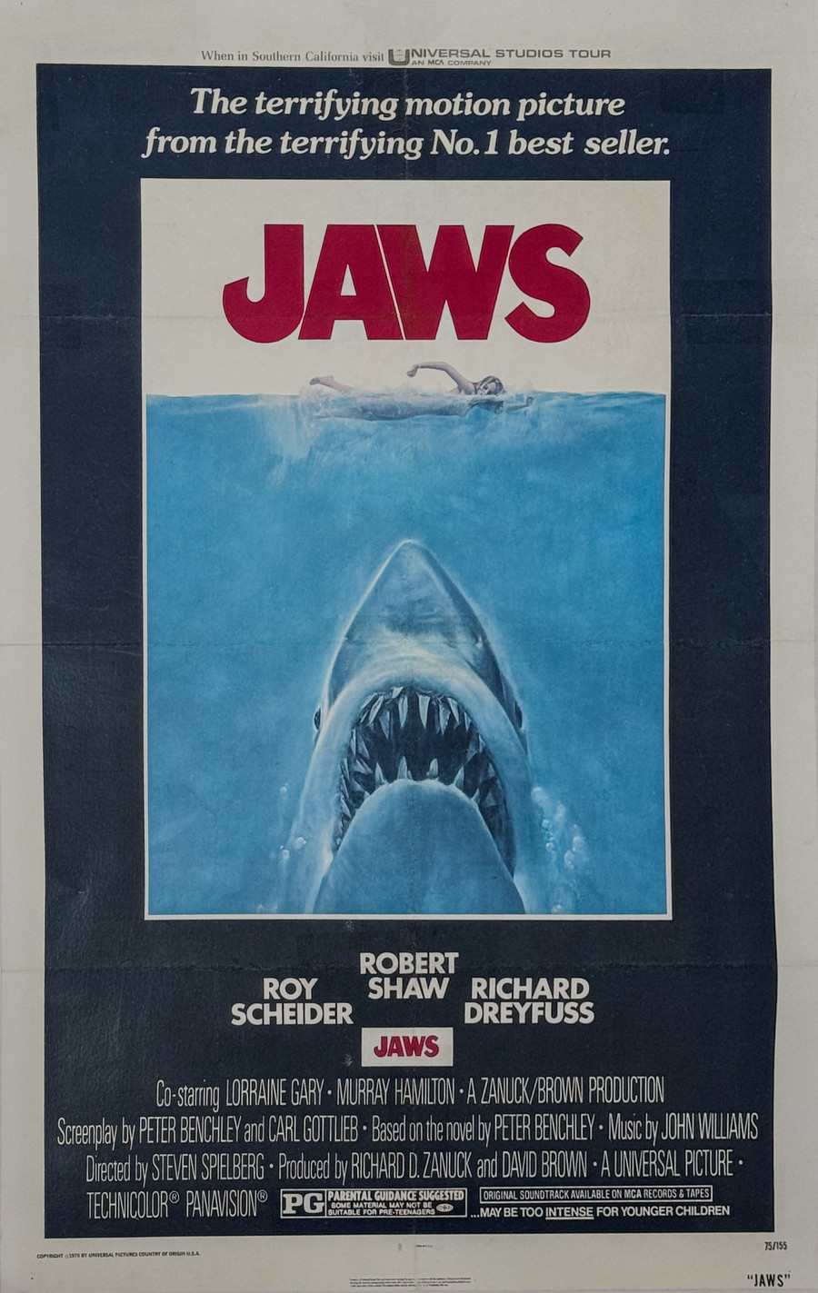 Jaws original 1975 style A vintage movie poster linen backed depicts shark launching from the ocean to feast on a female swimmer