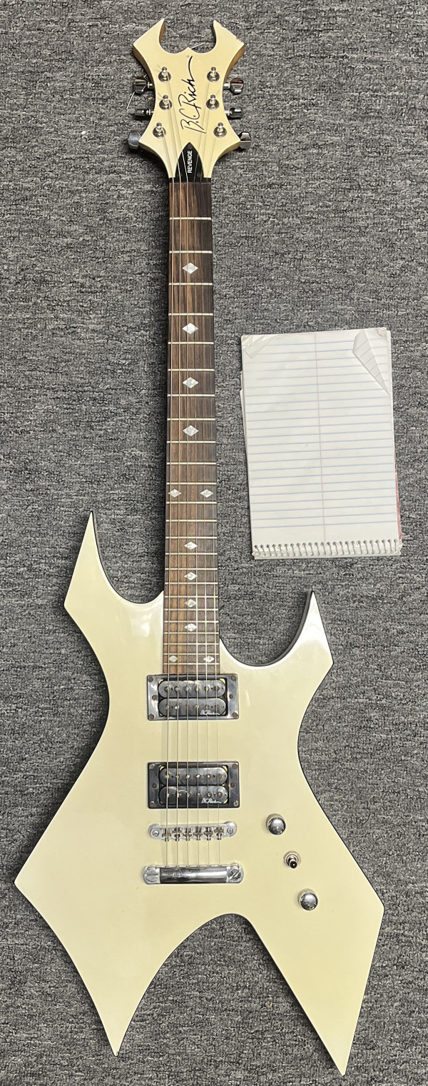 White paper included to illustrate the guitar is not "white"