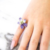 Enamel and gold flower ring on hand