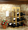 Oceanstar 12-Bottle Natural Bamboo Wine Rack holding wine bottles on a kitchen countertop with a flower pot beside it.