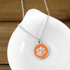 Clemson Tigers Cutout Necklace, orange and silver paw print pendant on a silver chain, Clemson Tigers jewelry, collegiate accessory.