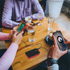 Portable power bank with 10000mAh capacity, LCD display, dual USB ports, and flashlight, shown in black and red color.