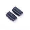 Two black cylindrical plastic pieces with logo embossing, lying on a white surface, possibly rubber or plastic end caps or covers.