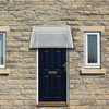 100 x 80 Household Application Door and Window Awnings RT, clear canopy, installed above dark blue front door and windows.
