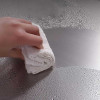 Stainless steel cutting board with hand wiping, Honesty House brand, stainless steel, wet surface, cleaning with towel, ideal for chefs and home cooks.