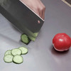Stainless steel cutting board with lip, slicing cucumber and tomato, kitchen utensil for food preparation, Honesty House brand kitchenware.