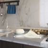 Honesty House stainless steel cutting board with lip for kitchen, on countertop beside sink, with eggs and flour.