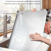 Honesty House stainless steel cutting board with lip for kitchen, being held by hands over sink, showcasing easy cleaning.