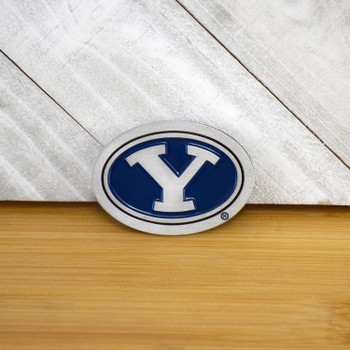 BYU Cougars Collectible Coin, blue and white oval logo with Y symbol on a wooden background, official team colors and emblem.