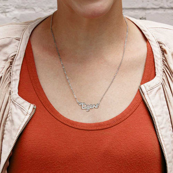 Clemson Tigers Script Necklace, silver chain with "Tigers" pendant, displayed on a person wearing rust top and beige jacket.