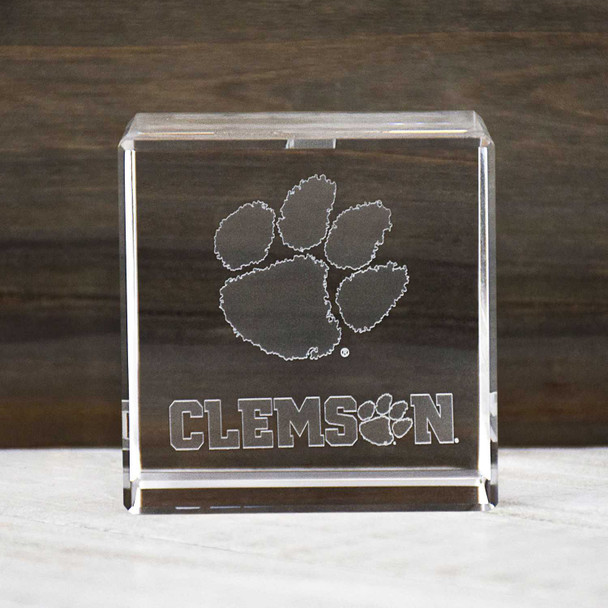 Clemson Tigers Paw Cube, clear glass paperweight with paw print and Clemson logo, college team spirit gift.