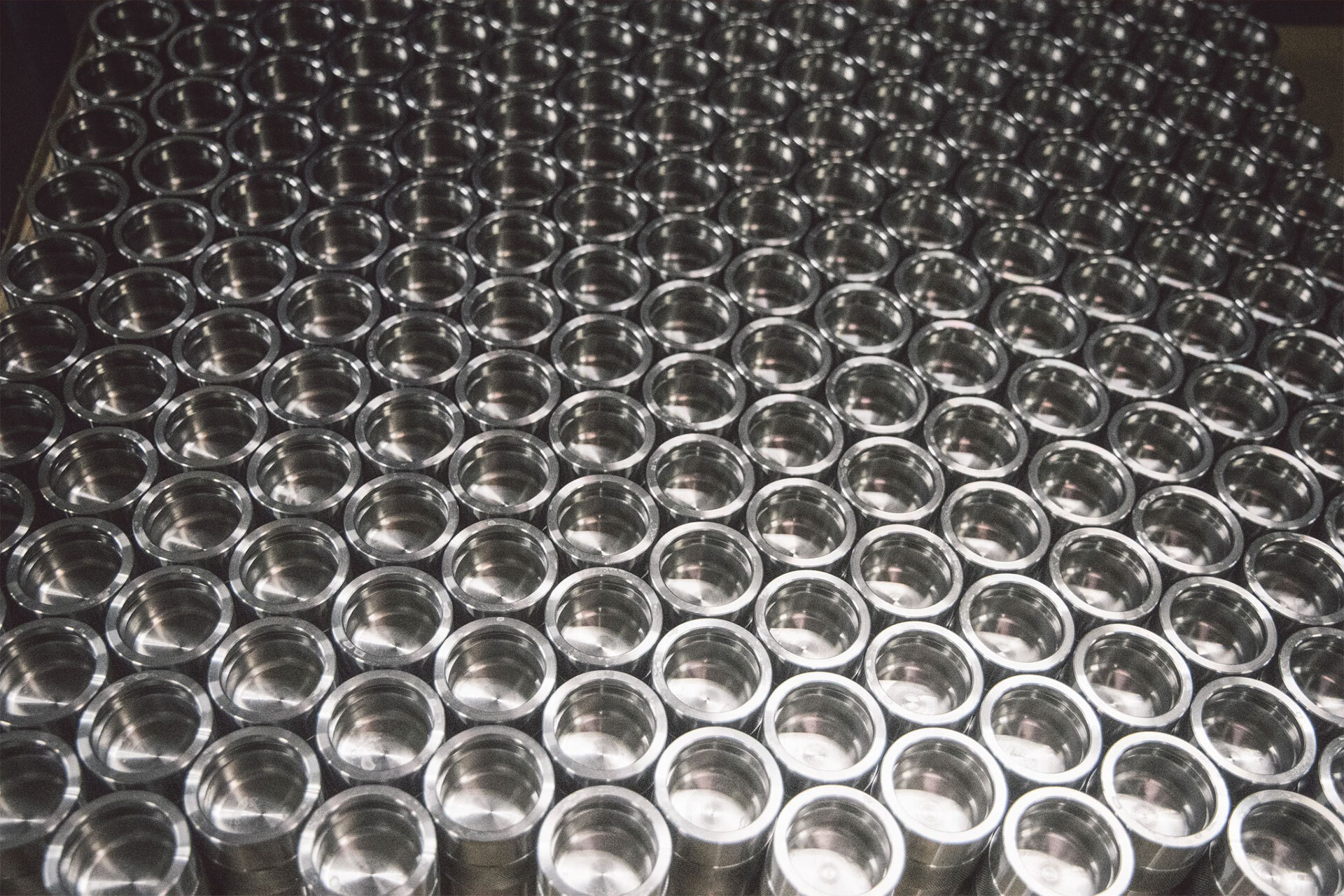 High-volume CNC turned aluminum bushings in production batch at Aerotech CNC Cleveland Ohio