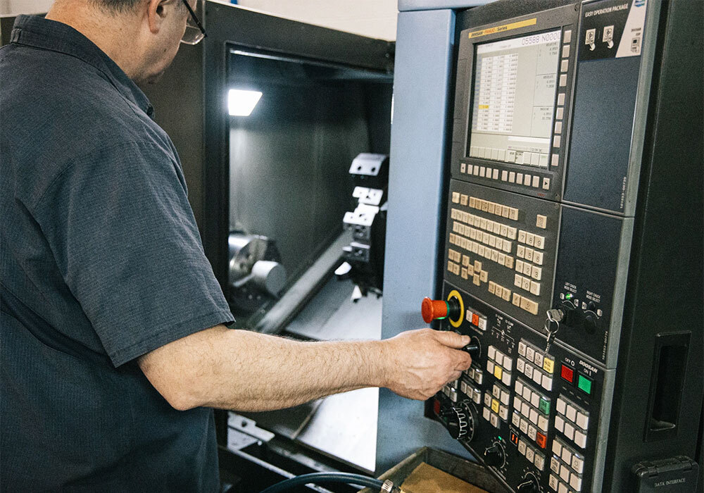 Aerotech CNC machinist operating a Doosan CNC lathe control panel in Cleveland, Ohio