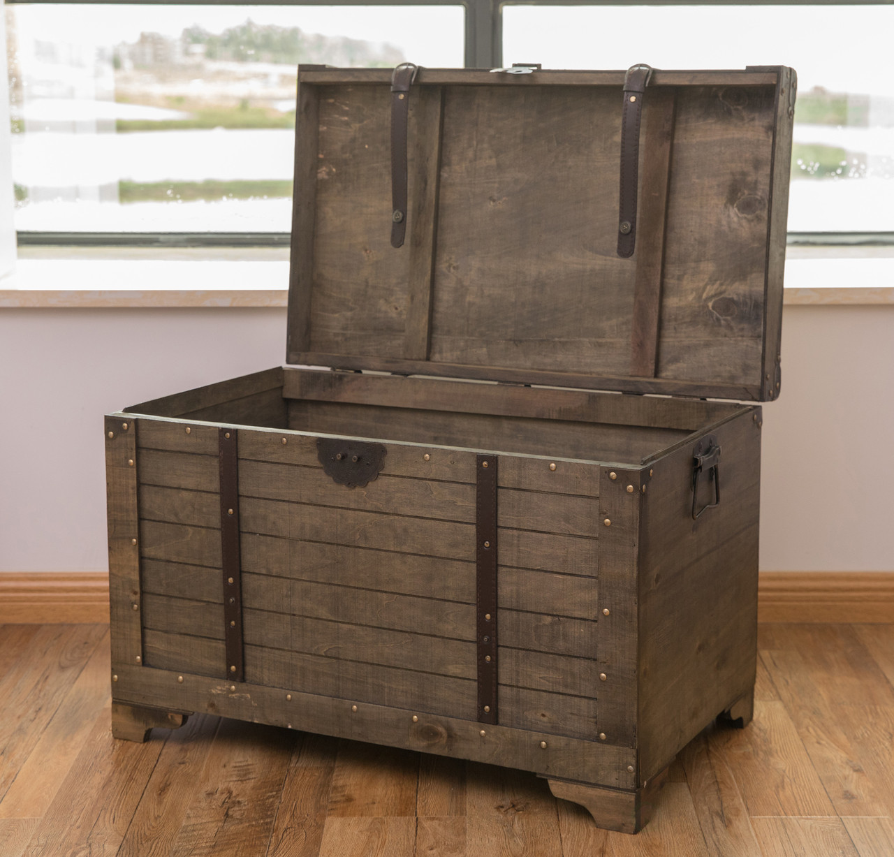 Antique wood trunk or chest used as a coffee table in a living area.  Beautiful! Rustic farmho…