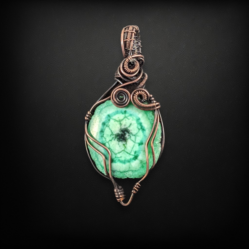 Copper wire wrapped pendant necklace featuring a dyed green agate cabochon.