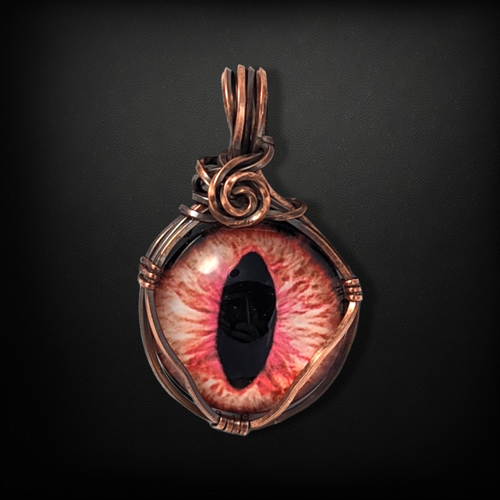 Copper wire wrapped pendant necklace featuring an eye cabochon.