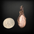 Copper wire wrapped pendant with a rose quartz cabochon