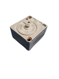 Honeywell, product image of a mechanical component with a square shape and circular features on top.