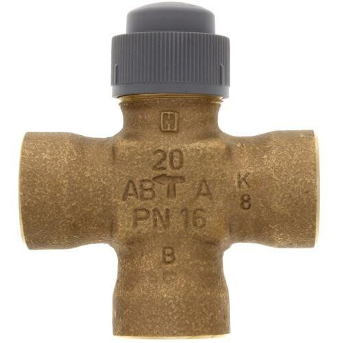 Honeywell Valve, a brass cross-shaped valve with a gray plastic cap on top.