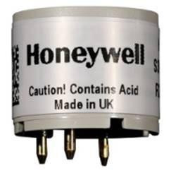 Honeywell product, close-up of Honeywell device with caution label indicating it contains acid and is made in UK.