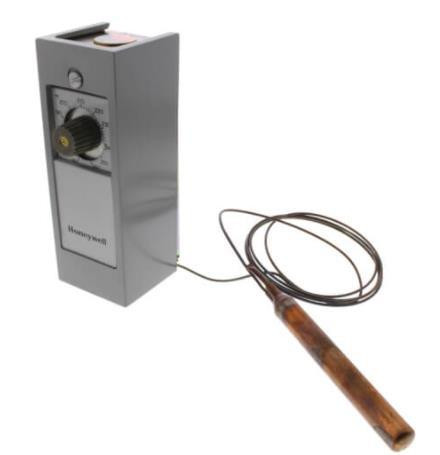 Honeywell electronic device, with a cylindrical probe connected by a wire.