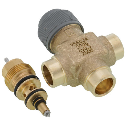 Honeywell, Brass and plastic plumbing valve with gray and brass fittings.
