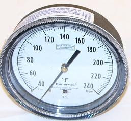 Honeywell thermometer, round analog temperature gauge with black markings and needle