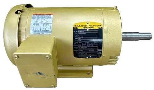Baldor Reliance Super E Motor, industrial electric motor with beige casing and metal shaft.