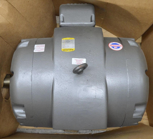 Baldor M2548T, industrial electric motor in grey, with labels and a handle, inside a wooden crate.