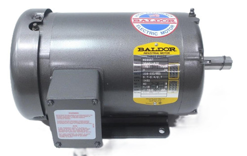 Baldor M3555T, industrial three-phase electric motor with a metallic gray finish and a label showing specifications.