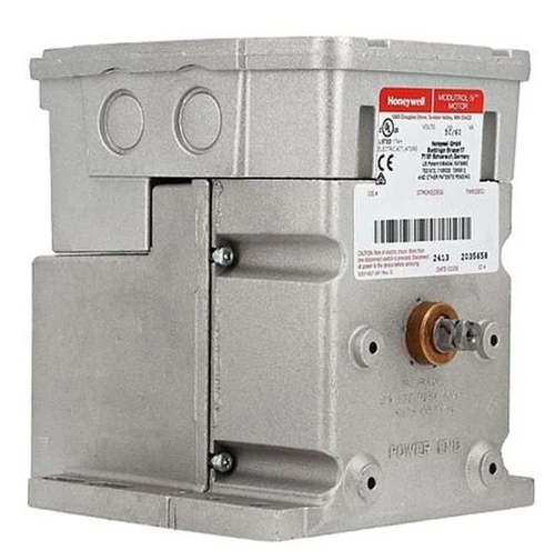 Honeywell M7284Q1007, industrial electrical component with metal casing, label with specifications, and terminal connections.