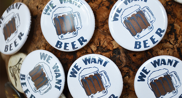 We Want Beer Buttons on a Cork Board