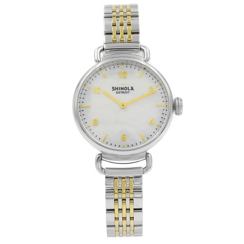 An image of a Wristwatch by Shinola. This Unworn item is designed for Women, featuring a Dress/Formal,Luxury style. It has a Quartz movement and an Analog display with a Mother of Pearl dial color. The indices include 12-Hour Dial,Arabic Numerals. The band is made of Stainless & Plated Metal and the case is made of Stainless Steel. The watch has a Round shape with a case size of 32 mm and a case thickness of 10 mm.