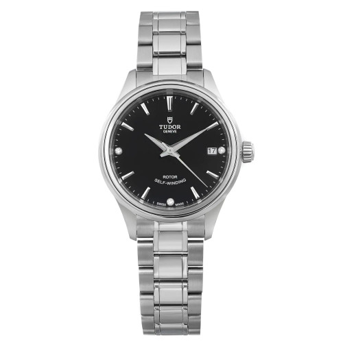 The image presents a close-up, straight-on view of a ladies' TUDOR Style 34mm wristwatch. This watch boasts a sleek diamond black dial with a date indicator located at the 3 o'clock position. The unworn stainless steel bracelet and case display a polished finish. The brand name and the text "Rotor Self-Winding" can be seen on the dial.