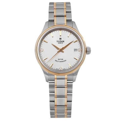 This is a Tudor wristwatch with a stainless steel and 18k yellow gold design. It features a silver dial, gold hands, and indices, along with a date display at the 3 o'clock position. The watch has a two-tone bracelet and is labeled as "Rotor Self-Winding," indicating it is an automatic watch.