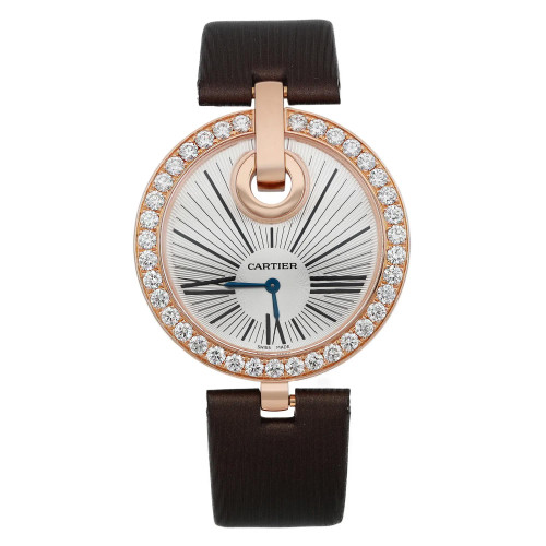 An image of a pre-owned Cartier Captive women's wristwatch, shown from a straight-on angle at a close distance. The watch features a round face with a rose gold bezel encrusted with diamonds. The dial has a sunburst pattern and Roman numeral hour markers, with blue hour and minute hands. The watch is attached to a brown strap.