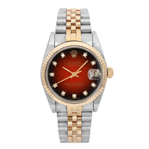 An image of a pre-owned wristwatch captured from a front full frontal view. The watch features a two-tone metal bracelet and a round face with a date display. The dial has a gradient design with hour markers and is set within a bezel. The crown is positioned on the right side. The image is taken from a close distance, highlighting the details of the watch's face and bracelet.