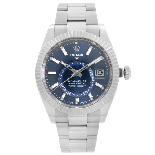 An image of a pre-owned wristwatch shown in a front full frontal view. The watch features a silver metal bracelet and a blue dial with luminous hour markers and hands. The date display is visible on the right side of the watch face. The bezel is fluted, and the crown is positioned on the right side. The image is taken from a close distance, capturing the detailed design of the timepiece.