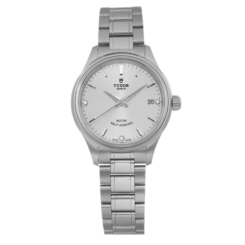 An image of a wristwatch taken from a front full-frontal view. The watch is unworn and features a silver metal bracelet and a matching silver dial. The brand name is visible on the dial, along with a date display on the right side. The image is positioned at a close distance, highlighting the watch's sleek and polished design.