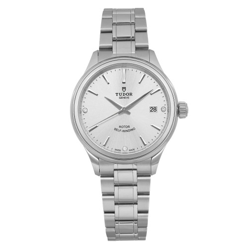 An image of a wristwatch in an unworn condition, captured from a front full frontal view. The watch displays a metallic bracelet and a round face with a minimalist design. The brand name is visible on the dial, showing precise details and a date feature on the right side. The image is taken at a close distance, highlighting the watch's craftsmanship and self-winding mechanism.