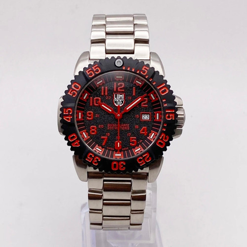 An image of a Wristwatch by Luminox. This Display Model item is designed for Men, featuring a Dress/Formal style. It has a Quartz movement and an Analog display with a Black dial color. The indices include 12-Hour Dial,Arabic Numerals,Easy to Read/Large Numerals. The band is made of Stainless Steel and the case is made of Stainless Steel. The watch has a Round shape with a case size of 44 mm and a case thickness of 13 mm.