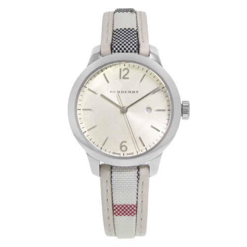 An image of a Wristwatch by Burberry. This Display Model item is designed for Women, featuring a Dress/Formal style. It has a Quartz movement and an Analog display with a Silver dial color. The indices include 12-Hour Dial,Arabic Numerals,Sticks. The band is made of Fabric/Canvas and the case is made of Stainless Steel. The watch has a Round shape with a case size of 32 mm and a case thickness of 8 mm.