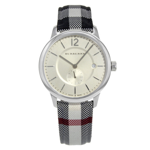 An image of a Wristwatch by Burberry. This Display Model item is designed for Unisex, featuring a Classic style. It has a Quartz movement and an Analog display with a Silver dial color. The indices include Sticks. The band is made of Fabric & Leather and the case is made of Stainless Steel. The watch has a Round shape with a case size of 40 mm and a case thickness of 8 mm.