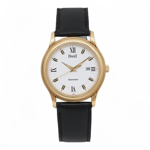An image of a pre-owned Piaget Polo 34mm 18K Yellow Gold White Dial Automatic Watch 24001 M501D positioned upright and centered. The watch face is directly facing the viewer, showing a white dial with Roman numerals and a date function. The yellow gold case is complemented by a black leather strap. The watch is captured from a straight-on angle at a close distance.