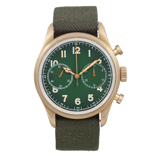 An image of a men's Montblanc wristwatch in excellent condition shown in a full frontal view. The watch features a round bronze case and a green dial with bronze-colored bezel. It has a casual style NATO band material in a matching green color. The dial includes Arabic numerals, a 12-hour display, and a small seconds subdial, with luminous hands and a chronograph function. The watch is positioned centrally with the face fully visible and the band partially rolled below, all against a neutral background.