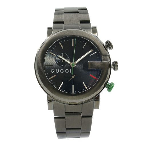 An image of a pre-owned Gucci men's wristwatch in good condition. The watch is captured from a front full frontal view at a medium distance, ensuring the entire watch is visible. It has a casual style with a black dial and bezel, stainless steel band and case, and a round shape. Stick indexes mark the hours on the 12-hour dial, with the Gucci logo prominently displayed at the center. The watch hands are visible, with a notable green second hand, and there are two crowns on the right side, one of which is accented in green.