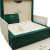 An image of a Rolex wristwatch box and documents, shown from a slightly elevated angle. The open box, positioned centrally, displays a plush interior with a slot for the watch. The green and gold brand logo is visible on the inner lid. A warranty card is positioned upright to the left of the box. The image captures the box from a close distance, highlighting its new condition.