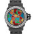 An image of a pre-owned wristwatch shown in a front close-up shot. The watch face features a colorful mosaic design with various geometric shapes in red, blue, green, yellow, and orange. The watch has a silver-tone bezel encrusted with two rows of sparkling stones. Silver hour and minute hands, along with a red second hand, are visible. The date display is positioned at the 6 o'clock mark. The watch is set against a sleek, dark metal bracelet.